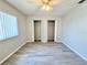 Spacious bedroom featuring modern gray floors, ceiling fan, and double closets at 615 Ridge Ter # 615, Winter Haven, FL 33881