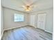 Inviting bedroom with plenty of natural light, wood-look floors, ceiling fan and a double closet at 615 Ridge Ter # 615, Winter Haven, FL 33881