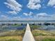 Picturesque lake view featuring a dock and clear blue skies provides a serene backdrop at 615 Ridge Ter # 615, Winter Haven, FL 33881