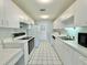 Well-lit kitchen features modern appliances, white cabinets, and tile flooring at 615 Ridge Ter # 615, Winter Haven, FL 33881