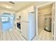 Bright kitchen with easy access to laundry, living room, and featuring all-white appliances at 615 Ridge Ter # 615, Winter Haven, FL 33881