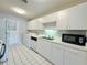 Well-maintained kitchen featuring white appliances, ample cabinet space, and tile floors at 615 Ridge Ter # 615, Winter Haven, FL 33881