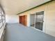 Enclosed lanai with tiled floor, sliding glass doors, and ample space for seating and storage at 615 Ridge Ter # 615, Winter Haven, FL 33881