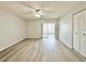 Spacious living room featuring a ceiling fan, wood-look floors, and sliding glass doors to the lanai at 615 Ridge Ter # 615, Winter Haven, FL 33881