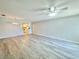 Open-concept living room with ceiling fan, hardwood floors, seamlessly connects to the kitchen at 615 Ridge Ter # 615, Winter Haven, FL 33881