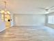 Bright and spacious living room with modern flooring and updated ceiling fan and light fixture at 615 Ridge Ter # 615, Winter Haven, FL 33881