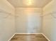 Walk-in closet featuring shelves for storing clothing and accessories, with wood-look flooring at 615 Ridge Ter # 615, Winter Haven, FL 33881
