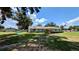 Expansive backyard view showcasing mature trees and lush lawn, offering ample space for recreation at 624 N Lanier Ave, Fort Meade, FL 33841