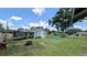 A lovely backyard featuring a trampoline, fire pit, and a small inflatable pool, perfect for outdoor enjoyment at 624 N Lanier Ave, Fort Meade, FL 33841
