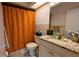 Bathroom featuring a granite-topped vanity and orange shower curtain at 624 N Lanier Ave, Fort Meade, FL 33841