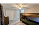 Spacious bedroom featuring wood-look flooring, ceiling fan, closet and a wooden bunk bed at 624 N Lanier Ave, Fort Meade, FL 33841