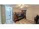 Bedroom featuring wood-look flooring, bunkbed, ceiling fan and access to an attached bathroom at 624 N Lanier Ave, Fort Meade, FL 33841