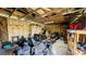 Well-lit garage equipped with shelving and various maintenance vehicles at 624 N Lanier Ave, Fort Meade, FL 33841