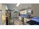 Open kitchen with modern appliances, granite countertops, and sleek white cabinetry at 624 N Lanier Ave, Fort Meade, FL 33841