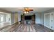Spacious living room with a ceiling fan and a decorative hutch at 624 N Lanier Ave, Fort Meade, FL 33841