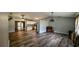 Open-concept living room showcasing modern flooring and seamless transition to the kitchen at 624 N Lanier Ave, Fort Meade, FL 33841