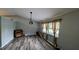 Bright living area with wood-look floors, large windows, and neutral paint at 624 N Lanier Ave, Fort Meade, FL 33841