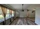 Inviting living room featuring stylish wood-look flooring and natural light from large windows at 624 N Lanier Ave, Fort Meade, FL 33841