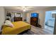 Comfortable main bedroom with wood-look floors, closet, and ceiling fan at 624 N Lanier Ave, Fort Meade, FL 33841
