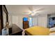Comfortable main bedroom with wood-look floors, closet, and ceiling fan at 624 N Lanier Ave, Fort Meade, FL 33841
