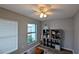 Bright room featuring wood-look floors, natural light and built-in shelving at 624 N Lanier Ave, Fort Meade, FL 33841