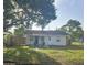 Backyard with wooden fence, green lawn, and a table and chairs seating area at 631 Julia Se St, Winter Haven, FL 33880