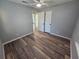 A bedroom featuring wood floors, modern ceiling fan, neutral walls, and closet doors at 631 Julia Se St, Winter Haven, FL 33880