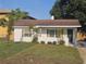 Charming home with a brown roof, well-kept lawn, and manicured landscaping at 631 Julia Se St, Winter Haven, FL 33880