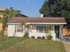 Charming single-story home featuring a brick facade, cozy front yard, and refreshed landscaping at 631 Julia Se St, Winter Haven, FL 33880