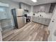 Modern kitchen with stainless steel appliances, sleek gray cabinets, and a stylish subway tile backsplash at 631 Julia Se St, Winter Haven, FL 33880