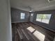 Bright living room featuring luxury vinyl plank floors, updated windows, and fresh neutral paint at 631 Julia Se St, Winter Haven, FL 33880
