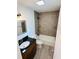 This bathroom features modern fixtures, and tile floors at 655 E Sanford St, Lake Alfred, FL 33850
