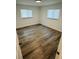 This bedroom features wood-look floors and natural light at 655 E Sanford St, Lake Alfred, FL 33850