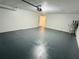 Spacious garage with a newly painted floor, ample room for parking and storage, and a well-lit interior at 655 E Sanford St, Lake Alfred, FL 33850