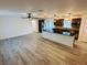 Open-concept living room and kitchen featuring modern flooring, a breakfast bar, and stylish pendant lighting fixtures at 655 E Sanford St, Lake Alfred, FL 33850
