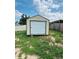 Exterior view of a storage shed in the backyard, providing ample storage space for tools and equipment on a grassy lot at 655 E Sanford St, Lake Alfred, FL 33850