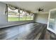 Bright sunroom with hardwood floors and large windows overlooking the backyard, creating a cozy space filled with natural light at 655 E Sanford St, Lake Alfred, FL 33850