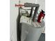Close-up of a new water heater installed in the utility area, showcasing modern plumbing and safety features at 655 E Sanford St, Lake Alfred, FL 33850