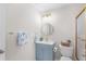 Bathroom featuring a modern sink, gold hardware, shower with glass door, and mounted towel rack at 703 Magnolia Pl # 703, Winter Haven, FL 33884