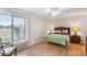 Bright bedroom featuring a large window, ceiling fan, and wood floors at 703 Magnolia Pl # 703, Winter Haven, FL 33884
