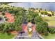 Aerial view of the community entrance showcasing landscaping, lake views, and beautiful foliage at 703 Magnolia Pl # 703, Winter Haven, FL 33884