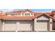 Three-car garage exterior showing numbered units with terra cotta tile roof at 703 Magnolia Pl # 703, Winter Haven, FL 33884
