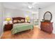 Bright main bedroom featuring a ceiling fan, wood floors, and ensuite bathroom at 703 Magnolia Pl # 703, Winter Haven, FL 33884