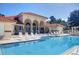 Outdoor swimming pool with chairs, lounge area, and tiled roof building at 703 Magnolia Pl # 703, Winter Haven, FL 33884
