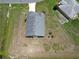 Birds-eye view showing the fenced-in backyard, gray roof, and long driveway at 830 Cabaret Ct, Kissimmee, FL 34759