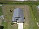 Aerial view of fenced home with spacious yard and long driveway at 830 Cabaret Ct, Kissimmee, FL 34759