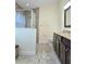 A bathroom features a tiled glass shower, a toilet, and a large vanity with granite countertops and cabinets at 830 Cabaret Ct, Kissimmee, FL 34759