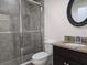 Beautiful bathroom featuring a glass shower, granite countertop, and decorative mirror at 830 Cabaret Ct, Kissimmee, FL 34759