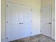 This bedroom is freshly painted and has a double doored closet, as well as another single door to access other areas at 830 Cabaret Ct, Kissimmee, FL 34759