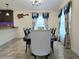 Dining room featuring modern decor, elegant window treatments, and natural light at 830 Cabaret Ct, Kissimmee, FL 34759